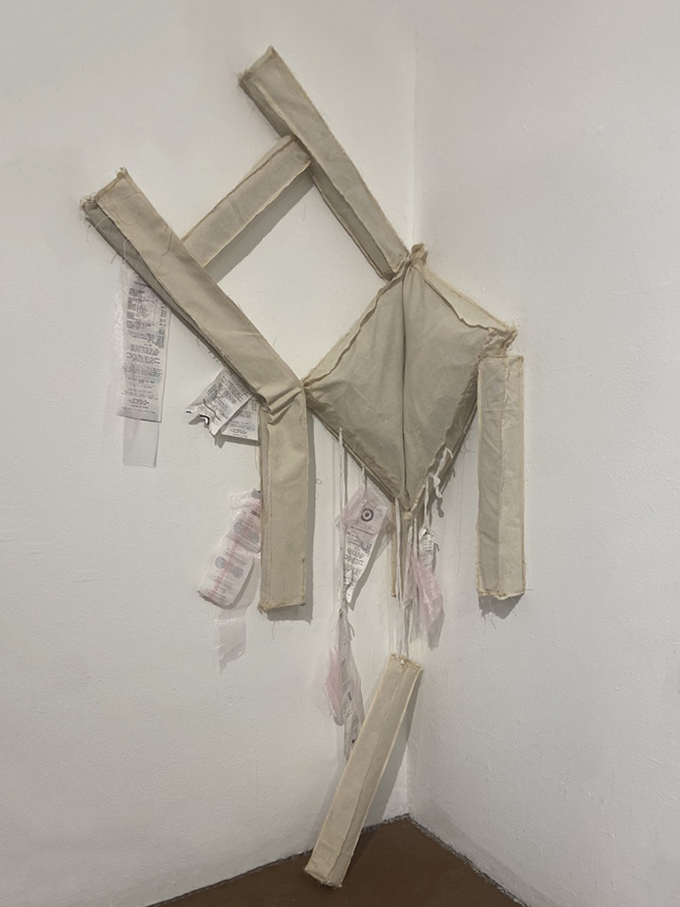 Fabric chair sculpture slumping into a gallery corner