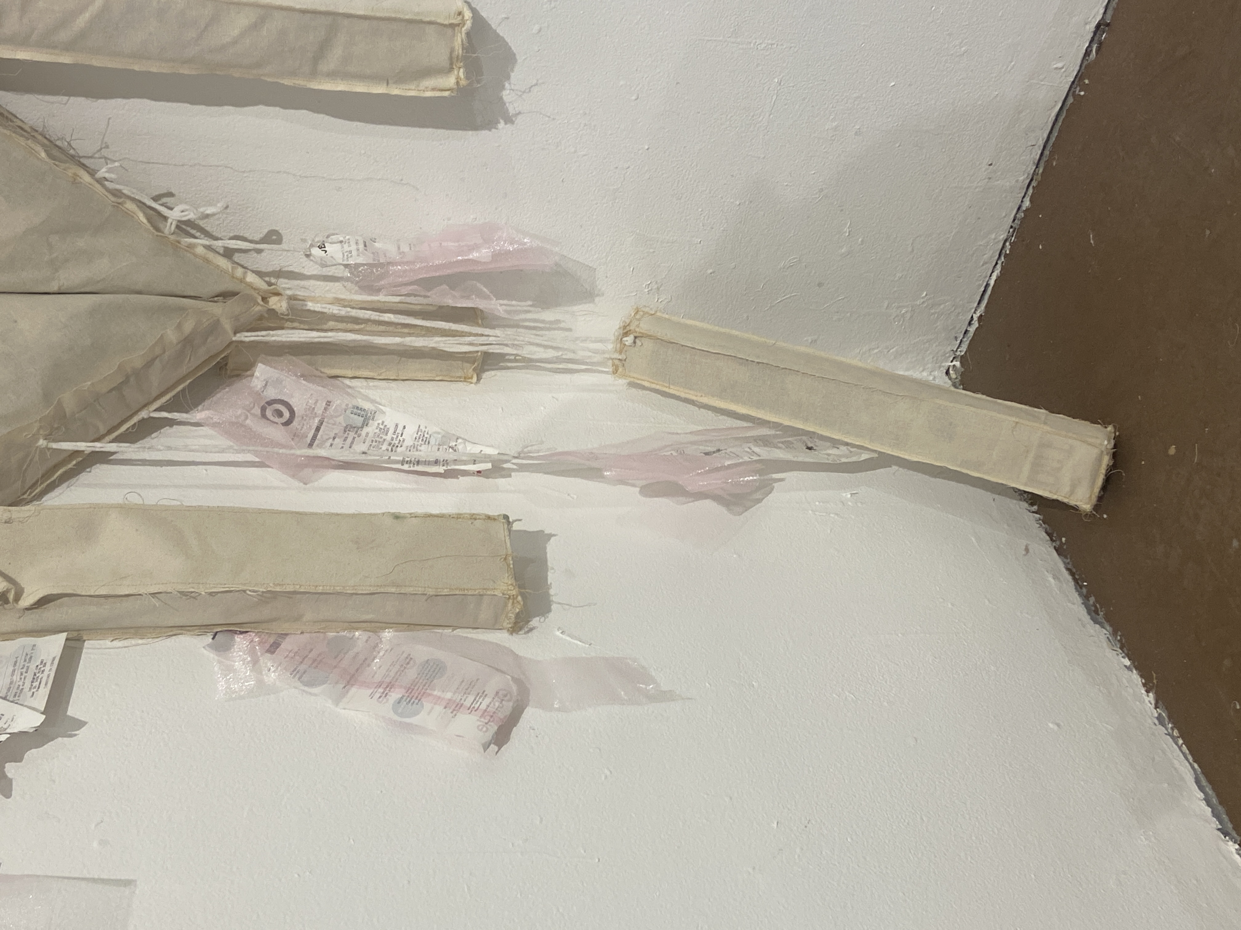 Close detail of receipts and hanging threads