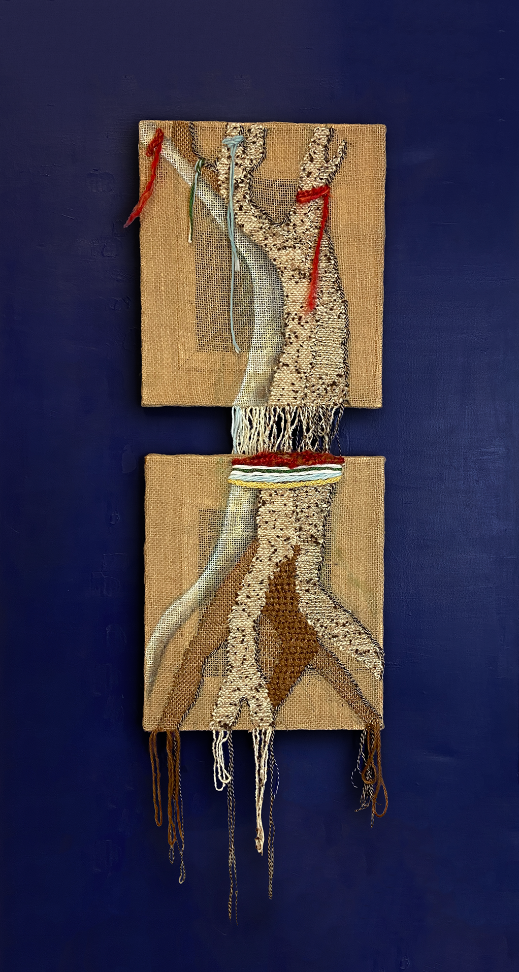 Long embroidered textile artwork with layered fibers