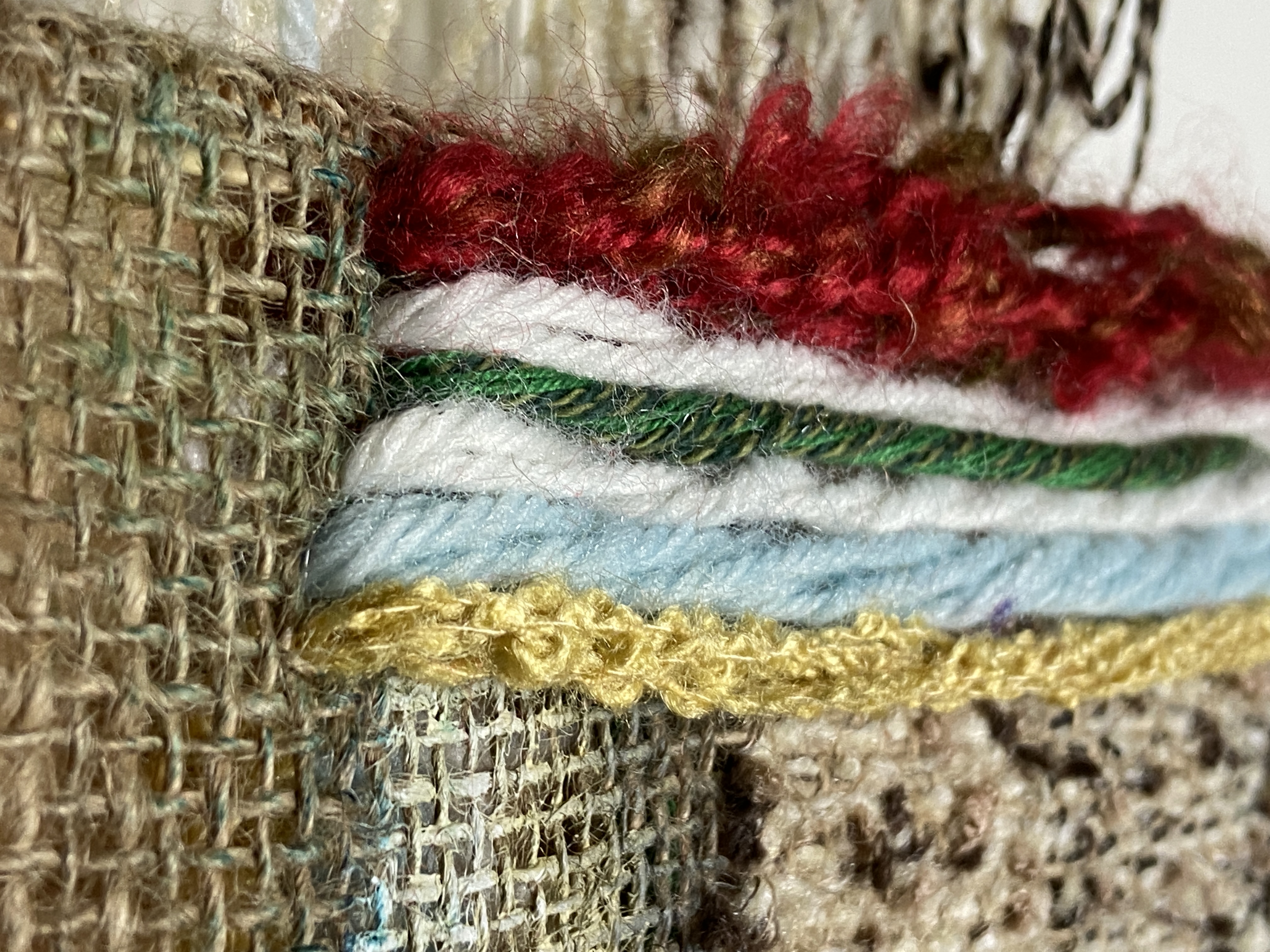 Close detail of layered yarn and burlap stitching